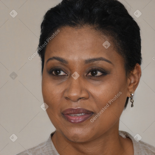 Joyful black adult female with short  brown hair and brown eyes