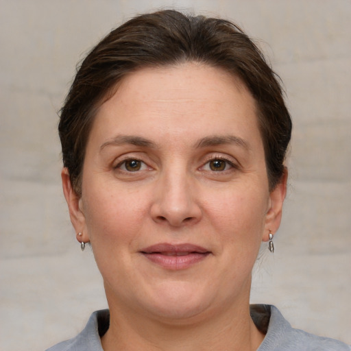 Joyful white adult female with short  brown hair and grey eyes