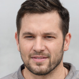 Joyful white adult male with short  brown hair and brown eyes