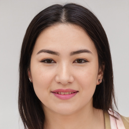 Joyful asian young-adult female with long  brown hair and brown eyes