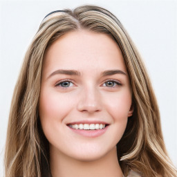 Joyful white young-adult female with long  brown hair and green eyes