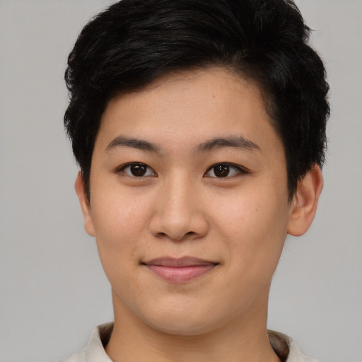 Joyful asian young-adult female with short  brown hair and brown eyes
