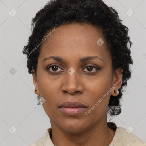 Joyful black adult female with short  black hair and brown eyes