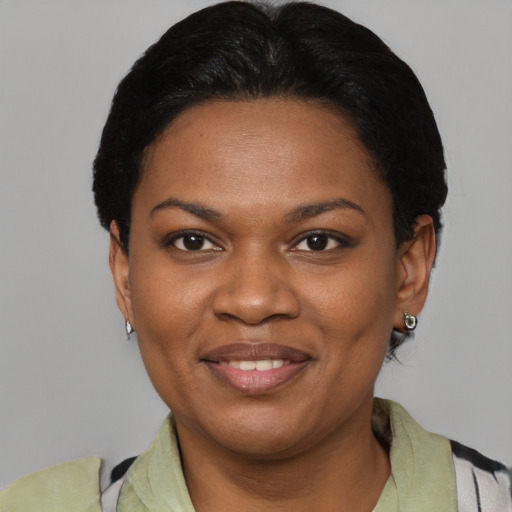 Joyful black young-adult female with short  black hair and brown eyes