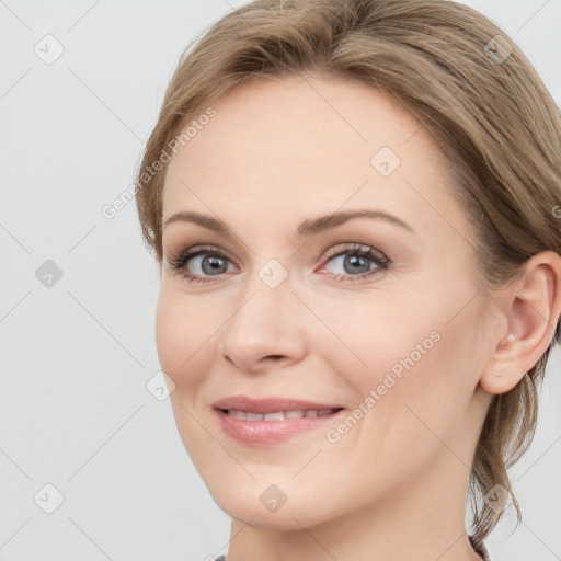 Joyful white young-adult female with long  brown hair and blue eyes