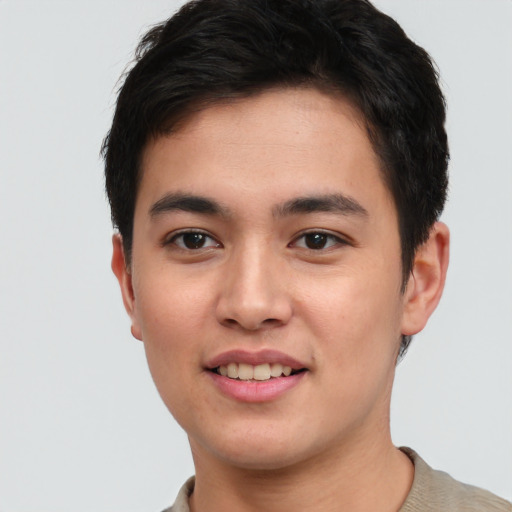 Joyful asian young-adult male with short  brown hair and brown eyes