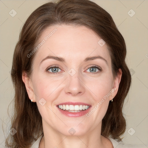 Joyful white adult female with medium  brown hair and green eyes