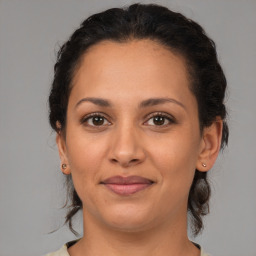 Joyful white adult female with medium  brown hair and brown eyes