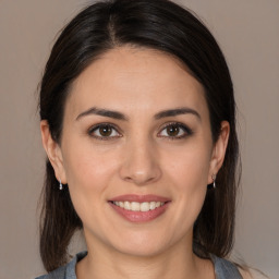 Joyful white young-adult female with medium  brown hair and brown eyes