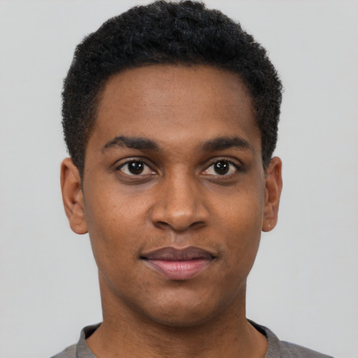 Joyful black young-adult male with short  black hair and brown eyes
