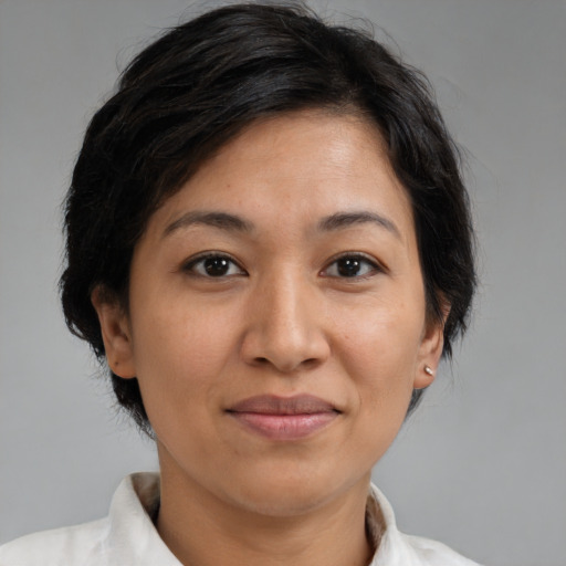 Joyful latino adult female with medium  brown hair and brown eyes