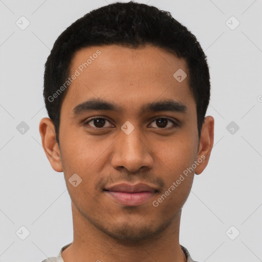 Joyful latino young-adult male with short  black hair and brown eyes