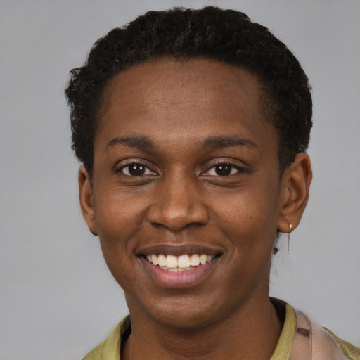 Joyful black young-adult male with short  black hair and brown eyes