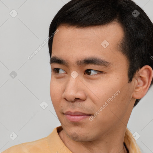 Joyful asian young-adult male with short  black hair and brown eyes