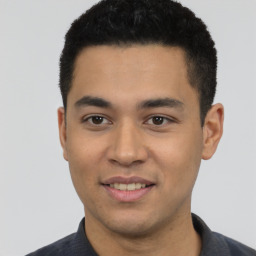 Joyful latino young-adult male with short  black hair and brown eyes