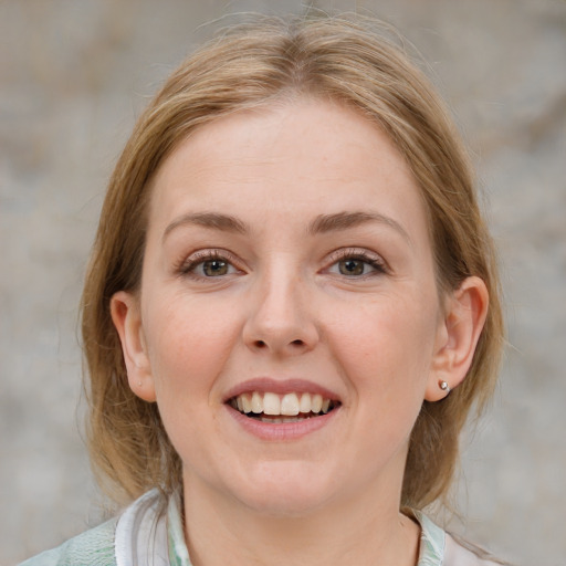 Joyful white young-adult female with medium  brown hair and blue eyes