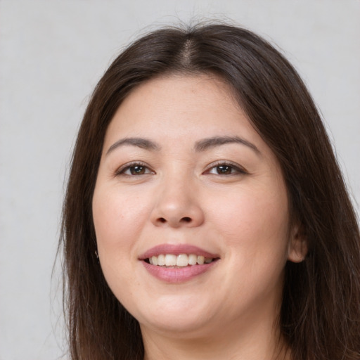 Joyful white young-adult female with long  brown hair and brown eyes