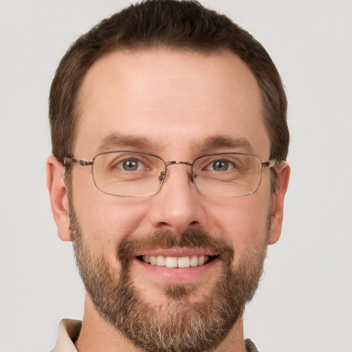 Joyful white adult male with short  brown hair and grey eyes