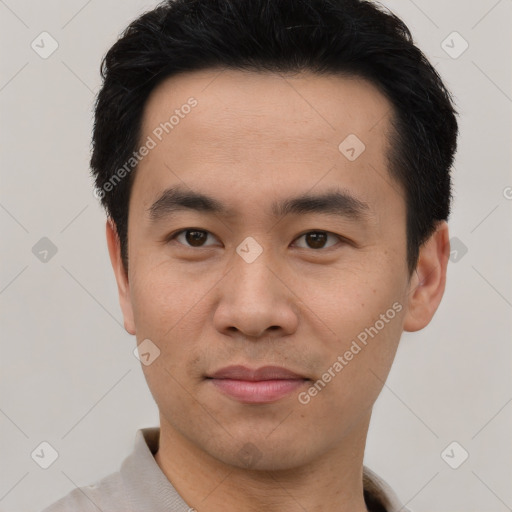 Joyful asian young-adult male with short  black hair and brown eyes