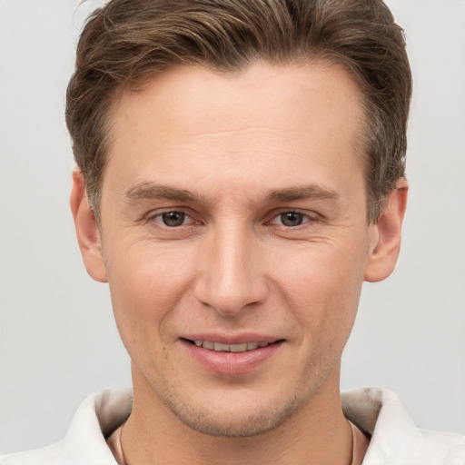 Joyful white adult male with short  brown hair and brown eyes