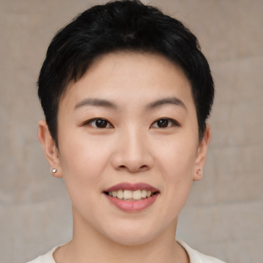 Joyful asian young-adult female with short  black hair and brown eyes