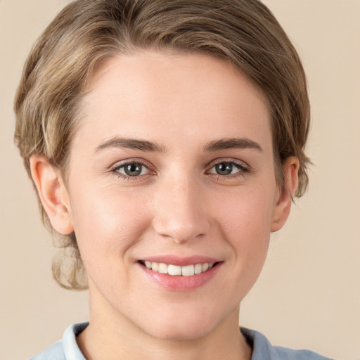 Joyful white young-adult female with short  brown hair and grey eyes