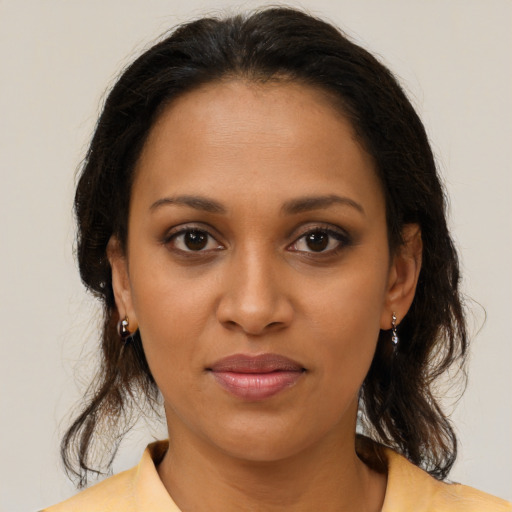 Joyful black young-adult female with medium  brown hair and brown eyes