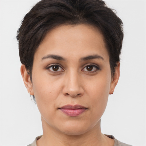 Joyful latino young-adult female with short  brown hair and brown eyes