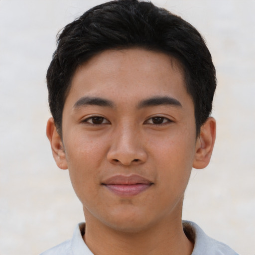 Joyful asian young-adult male with short  brown hair and brown eyes