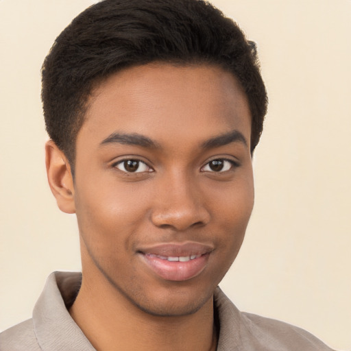 Joyful black young-adult male with short  brown hair and brown eyes