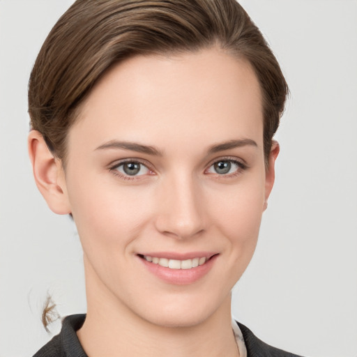 Joyful white young-adult female with short  brown hair and grey eyes