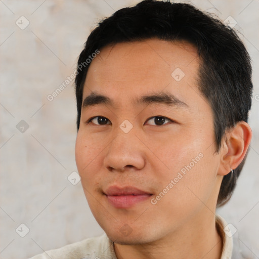 Joyful asian young-adult male with short  black hair and brown eyes