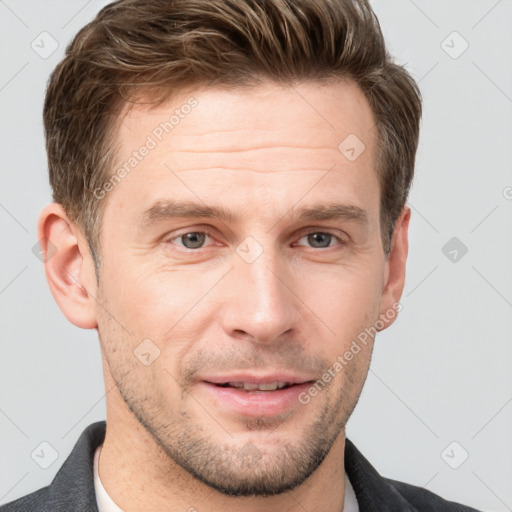 Joyful white adult male with short  brown hair and grey eyes