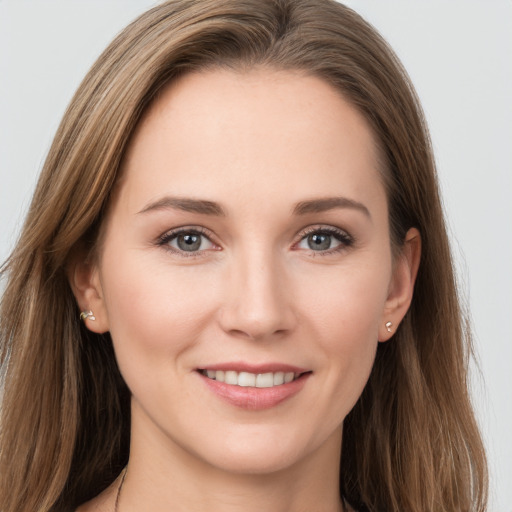 Joyful white young-adult female with long  brown hair and brown eyes