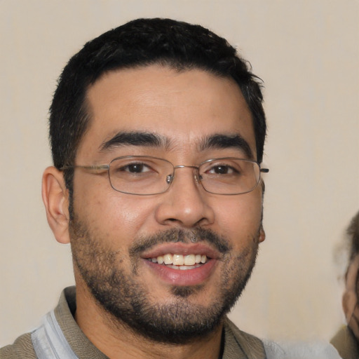 Joyful asian young-adult male with short  black hair and brown eyes