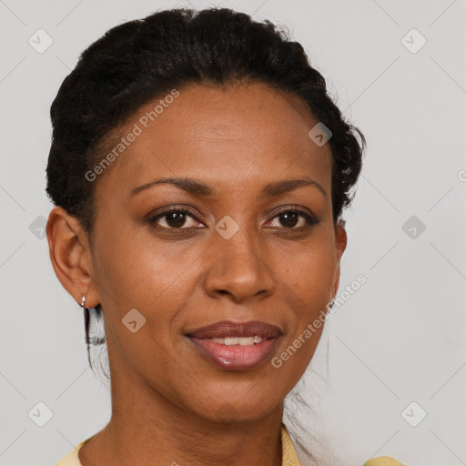 Joyful black adult female with short  brown hair and brown eyes