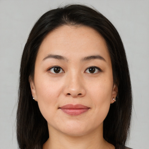 Joyful asian young-adult female with medium  brown hair and brown eyes