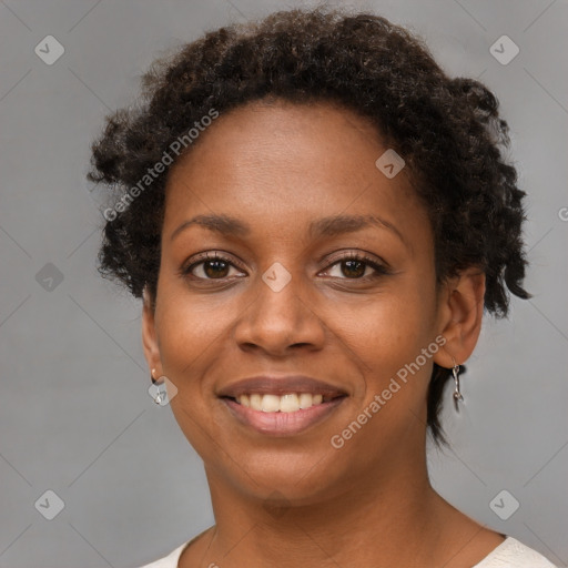 Joyful black young-adult female with short  brown hair and brown eyes