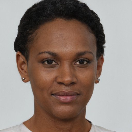 Joyful black young-adult female with short  brown hair and brown eyes