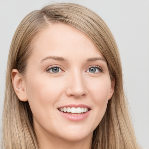 Joyful white young-adult female with long  brown hair and grey eyes