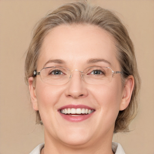 Joyful white adult female with medium  brown hair and blue eyes