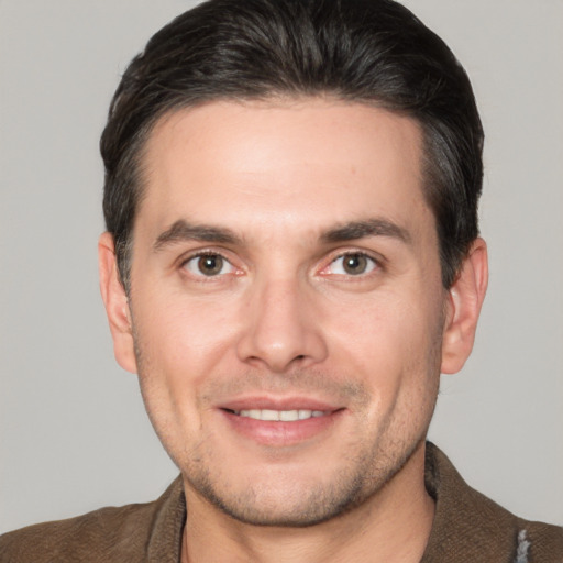 Joyful white adult male with short  brown hair and brown eyes