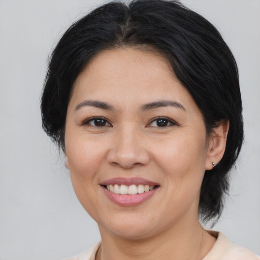 Joyful asian young-adult female with medium  brown hair and brown eyes