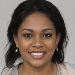 Joyful black young-adult female with medium  brown hair and brown eyes