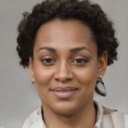 Joyful black adult female with short  brown hair and brown eyes