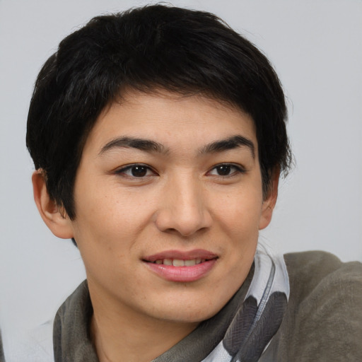 Joyful asian young-adult female with short  brown hair and brown eyes