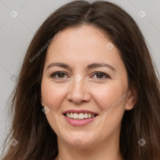 Joyful white adult female with long  brown hair and brown eyes