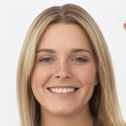 Joyful white young-adult female with long  brown hair and green eyes