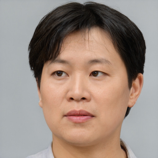 Joyful asian adult female with short  brown hair and brown eyes