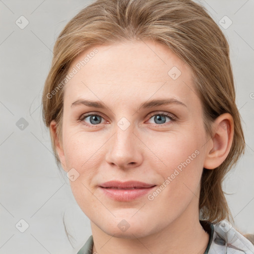 Joyful white young-adult female with medium  brown hair and blue eyes